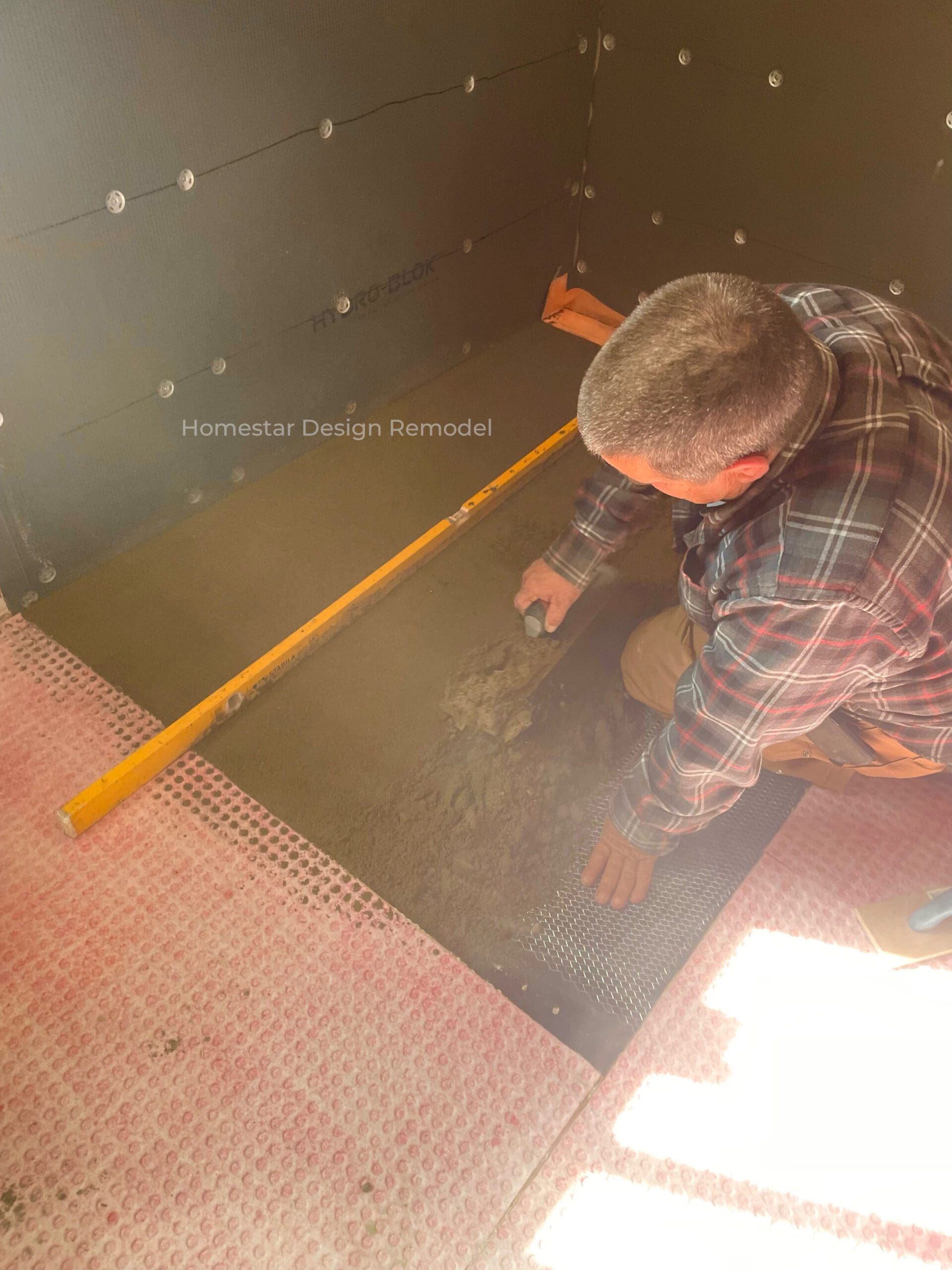 A custom-poured dry pack shower base for a curbless shower.