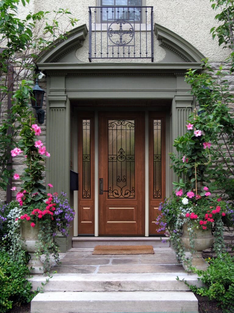 Wooden front exterior door with black cast iron grids in St. Louis, MO.