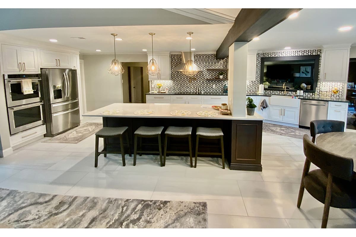 A major kitchen remodel performed in St. Louis, MO County, featuring a white and dark brown color scheme and the removal of a load bearing wall.